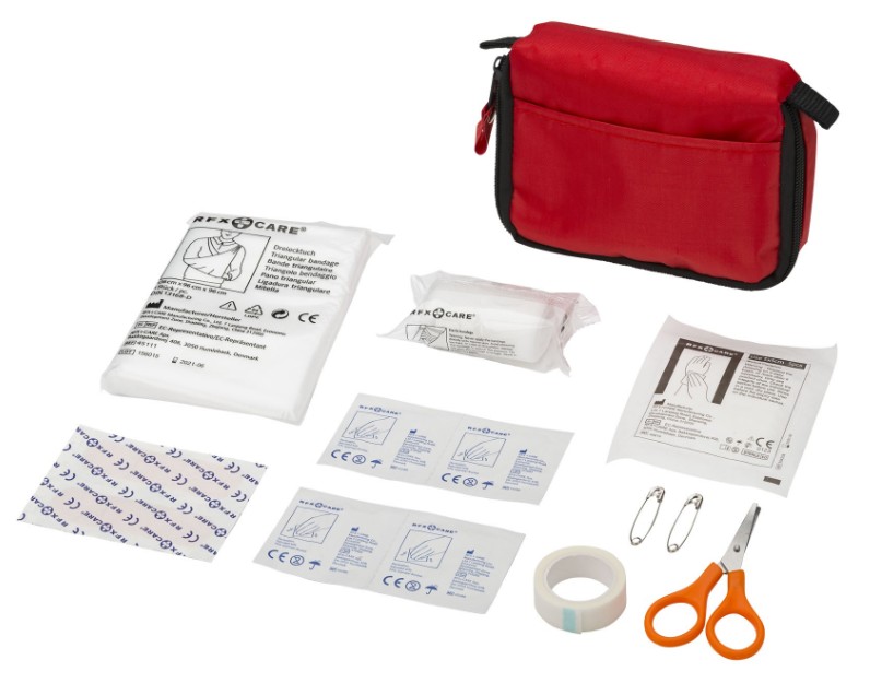 Travel medical kit with thermometer, bandages, essential medications, insect repellent, and sunscreen, prepared for summer holidays.